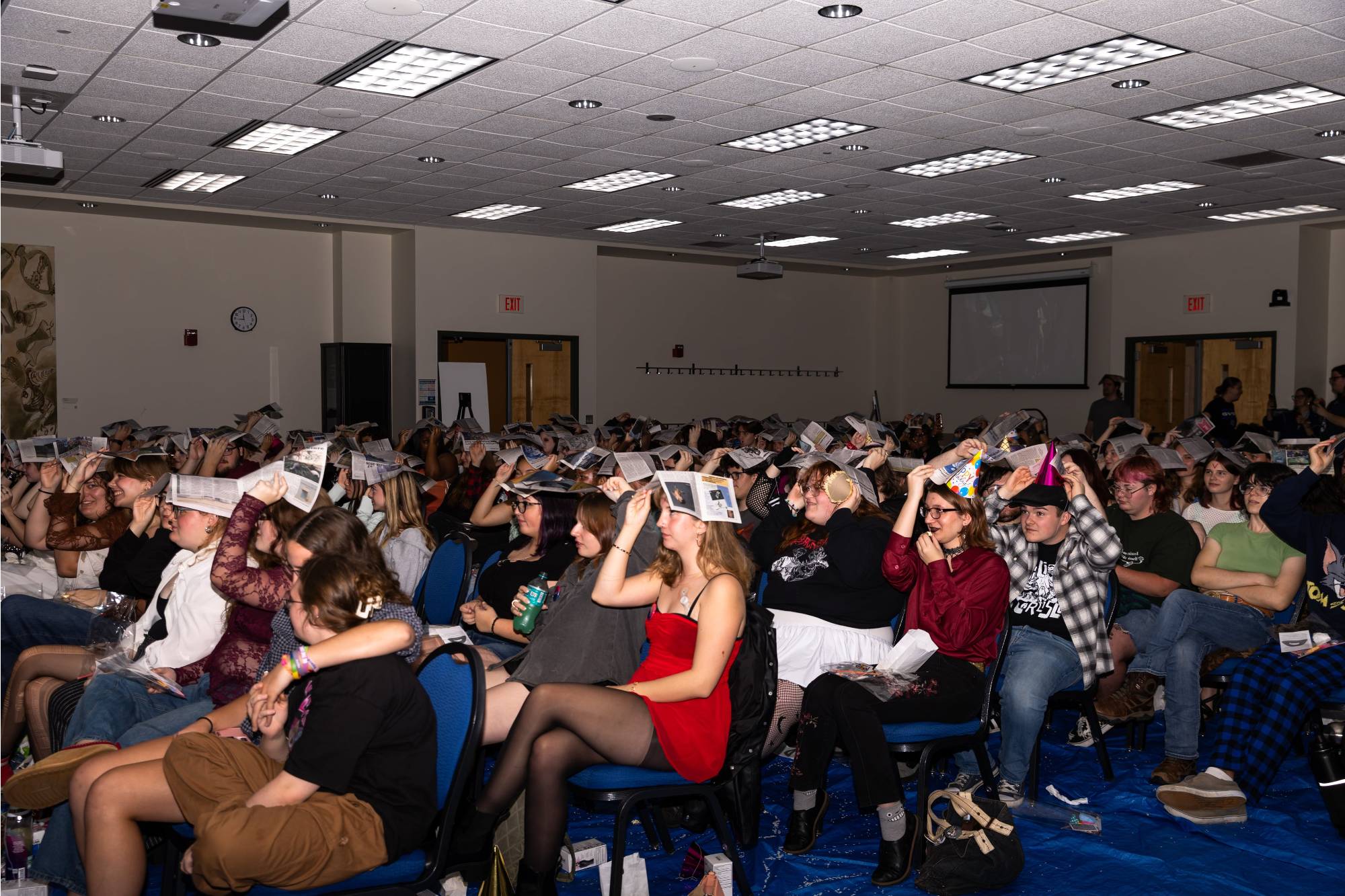 Students with newspapers over their heads